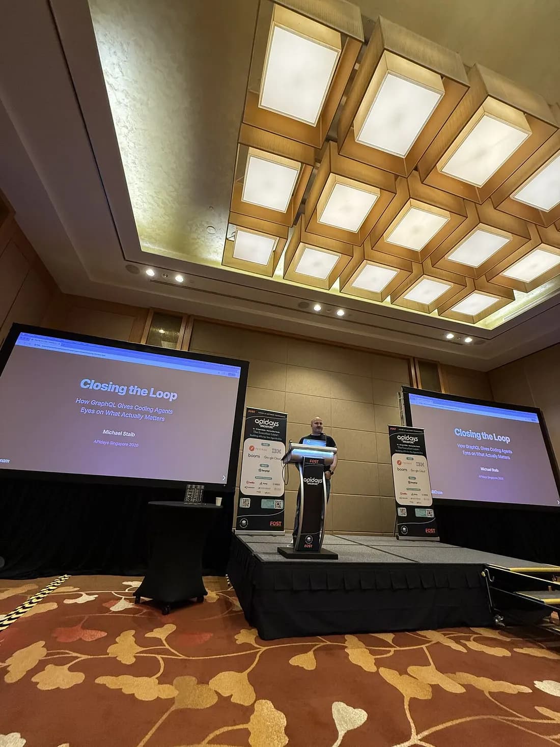 Akshat speaking on stage at API Days